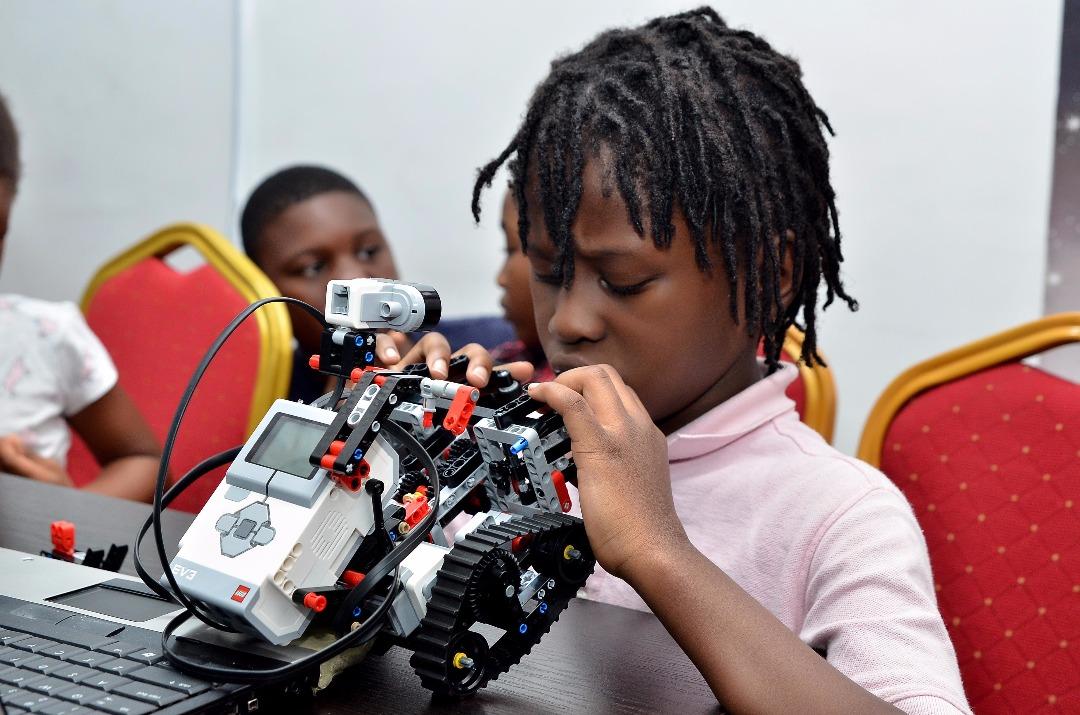A child assembling a robotics kit during a Toko Academy weekend class