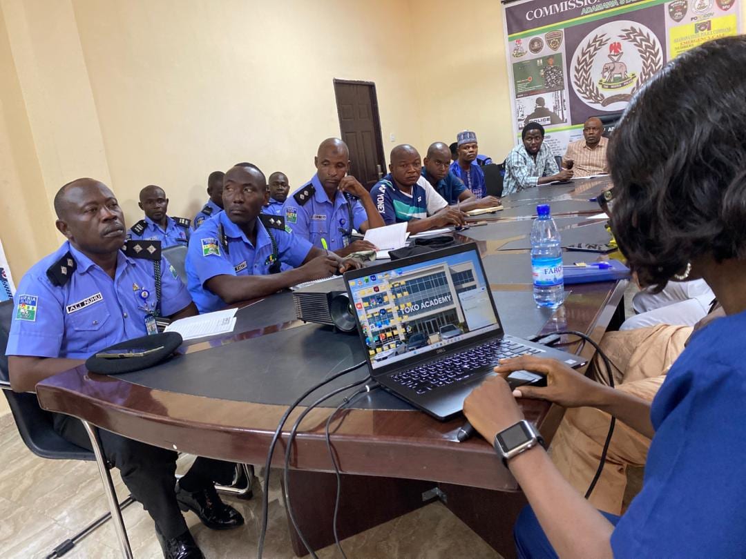 A Toko Academy facilitator working with a client team around the table during a corporate session in Yola