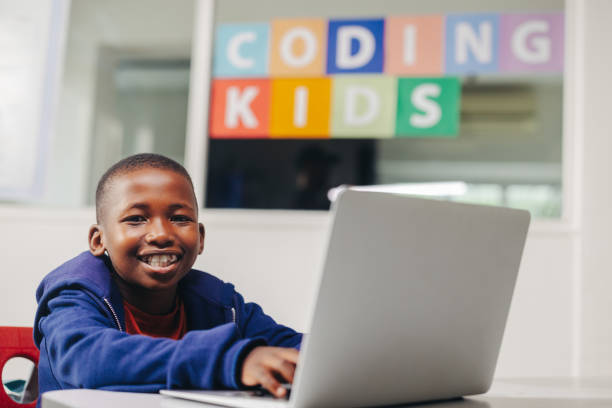 A young learner working at a laptop in a coding class